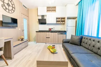 a living room with a couch and a kitchen at MELİSA SUİT RESİDENCE in Istanbul