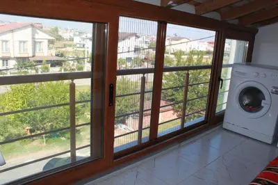 a laundry room with a window and a washing machine at yelken apart hotel in Tekirdag