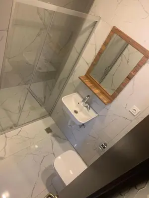 a bathroom with a sink and a mirror and a toilet at Royal Residence Bursa in Bursa