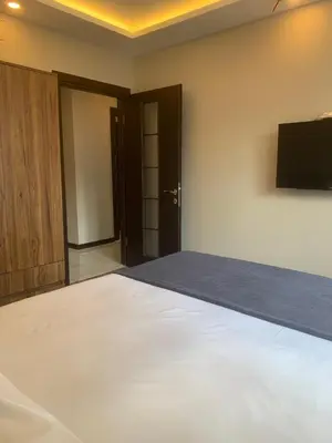 a bedroom with a bed and a flat screen tv at Royal Residence Bursa in Bursa