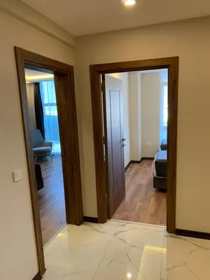 a hallway with two doors and a living room at Royal Residence Bursa in Bursa