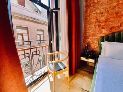 a bedroom with a bed and a window and a chair at RUZ Hotels in Istanbul