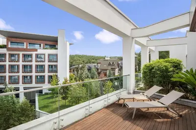 a balcony with two chairs and a building at Radisson Blu Hotel & Spa, Istanbul Tuzla in Istanbul