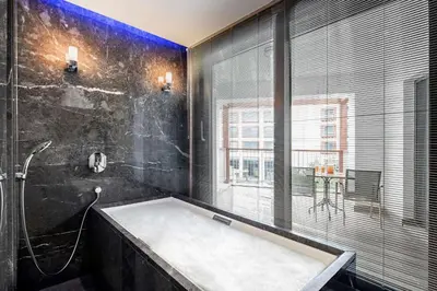 a bathroom with a large tub and a window at Radisson Blu Hotel & Spa, Istanbul Tuzla in Istanbul
