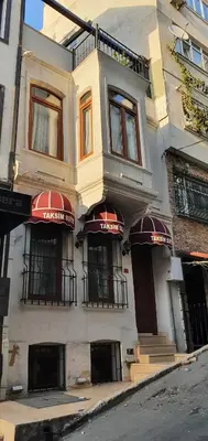 a building with red awnings on the front of it at TAKSİM SUİTE in Istanbul