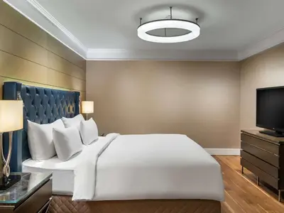a bedroom with a large white bed and a flat screen tv at Radisson Blu Hotel, Istanbul Sisli in Istanbul