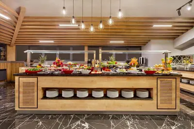 a buffet in a restaurant with a lot of food at Ramada Encore by Wyndham Istanbul Avcilar in Istanbul