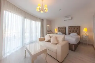 a living room with a couch and a bed at Motali Life Hotel in Masukiye