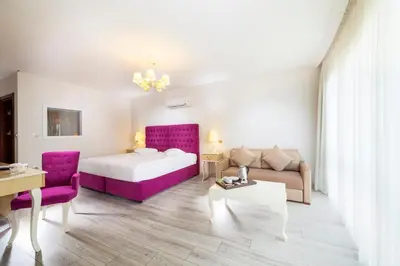 a hotel room with a bed and a couch at Motali Life Hotel in Masukiye