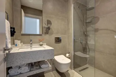 a bathroom with a toilet and a sink and a shower at The Pearl Suites in Istanbul