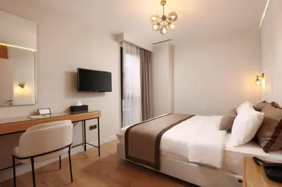 a hotel room with a bed and a desk at The Pearl Suites in Istanbul
