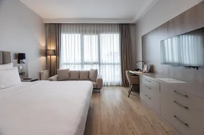 a hotel room with a large bed and a couch at Antwell Suites in Istanbul