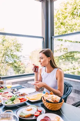 a woman sitting at a table with plates of food at RW BOUTIQUE HOTEL in Istanbul