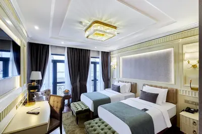 a hotel room with two beds and a desk at Aspera Hotel Golden Horn in Istanbul