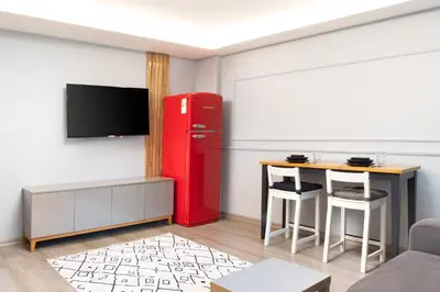 a living room with a red refrigerator and a table at Family Time Suites Hotel in Istanbul
