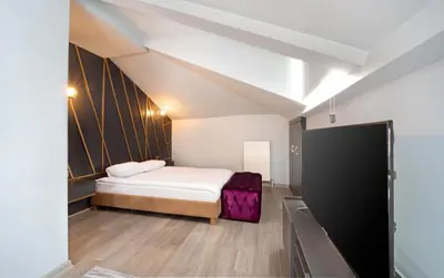 a small room with a bed and a tv at Family Time Suites Hotel in Istanbul
