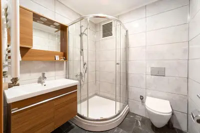 a bathroom with a shower and a sink and a toilet at Family Time Suites Hotel in Istanbul