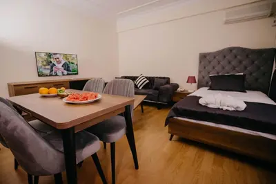 a bedroom with a bed and a table with a bowl of fruit at Istanbul Galata Port Modern Suite & Apartments Taksim in Istanbul