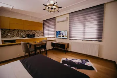 a room with a kitchen with a table and a bed at Istanbul Galata Port Modern Suite & Apartments Taksim in Istanbul