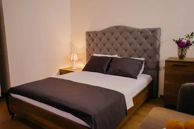 a bedroom with a large bed with a large headboard at Istanbul Galata Port Modern Suite & Apartments Taksim in Istanbul