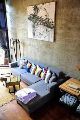 a living room with a blue couch with pillows at Minimalist Sapanca in Sapanca