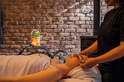a woman is performing a massage on a woman lying on a bed at Minimalist Sapanca in Sapanca