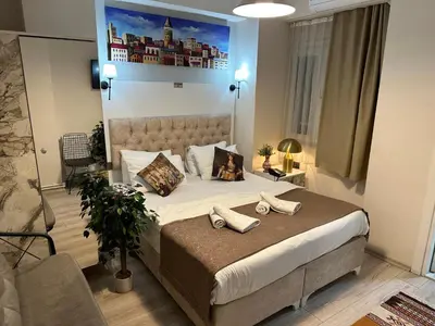 a bedroom with a large bed with two shoes on it at Galapera Apartments in Istanbul