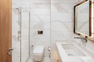 a bathroom with a toilet and a sink and a tub at Residence Inn by Marriott Istanbul Atasehir in Istanbul