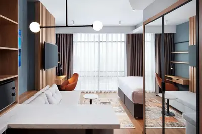 a hotel room with a king sized bed and a living room at Residence Inn by Marriott Istanbul Atasehir in Istanbul