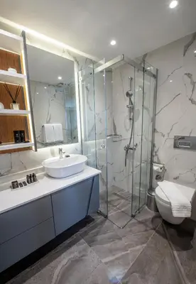 a bathroom with a sink and a shower and a toilet at Valente Suites&Hotel in Istanbul