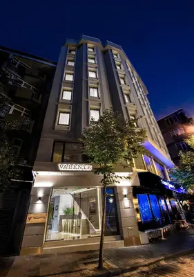 a tall building with a tree in front of it at Valente Suites&Hotel in Istanbul