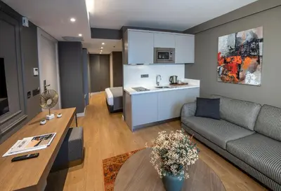 a living room with a couch and a kitchen at Valente Suites&Hotel in Istanbul