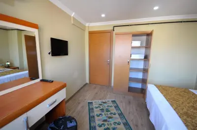 a hotel room with a bed and a bathroom with a tv at Marida Residence - Istanbul Taksim in Istanbul