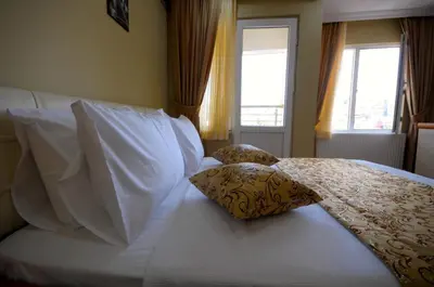 a bedroom with a white bed with two pillows at Marida Residence - Istanbul Taksim in Istanbul