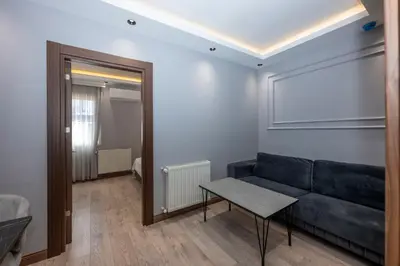 a living room with a couch and a table at Comfort Suites Hotel in Istanbul