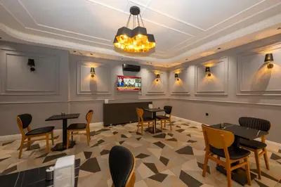 a restaurant with tables and chairs and a ceiling at Comfort Suites Hotel in Istanbul