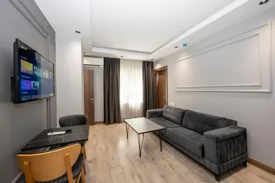 a living room with a couch and a flat screen tv at Comfort Suites Hotel in Istanbul