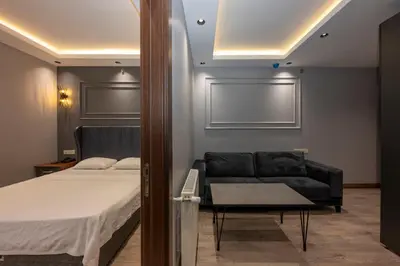 a bedroom with a bed and a black couch at Comfort Suites Hotel in Istanbul