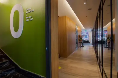 an office corridor with a green sign on the wall at Dosso Dossi Hotels Yenikapı in Istanbul