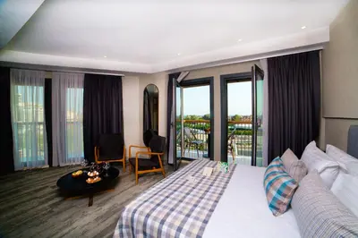 a hotel room with a bed and a balcony at Dosso Dossi Hotels Yenikapı in Istanbul