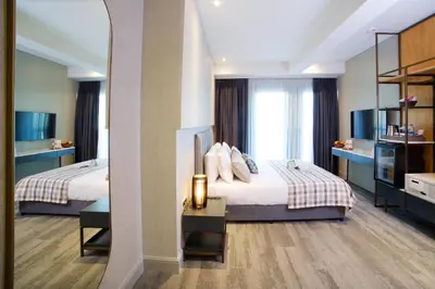a hotel room with two beds and a mirror at Dosso Dossi Hotels Yenikapı in Istanbul