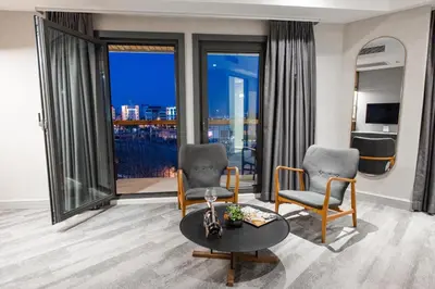 a living room with two chairs and a table at Dosso Dossi Hotels Yenikapı in Istanbul