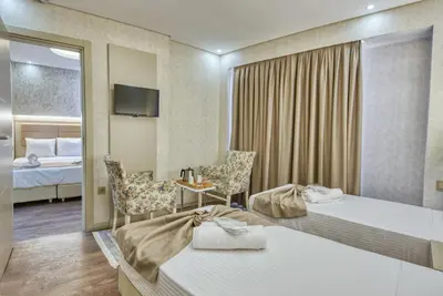 a hotel room with two beds and a mirror at Florina Hotel in Istanbul