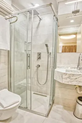a bathroom with a shower and a toilet and a sink at Florina Hotel in Istanbul