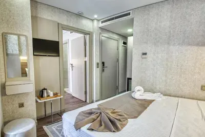 a bedroom with a bed with a bow on it at Florina Hotel in Istanbul