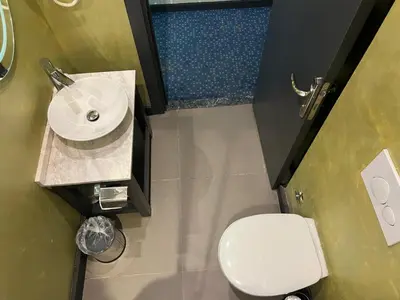 a bathroom with a white sink and a toilet at Acar Suite Hotel in Istanbul
