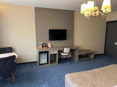 a hotel room with a desk with a television at Acar Suite Hotel in Istanbul