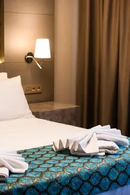 a hotel room with a bed with towels on it at Acar Suite Hotel in Istanbul