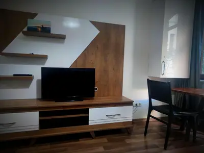 a living room with a desk with a television on it at Mimoza İstiklal Apart Hotel in Istanbul