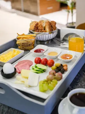 a tray filled with different types of food on a table at Merlin Hotel İstanbul in Istanbul
